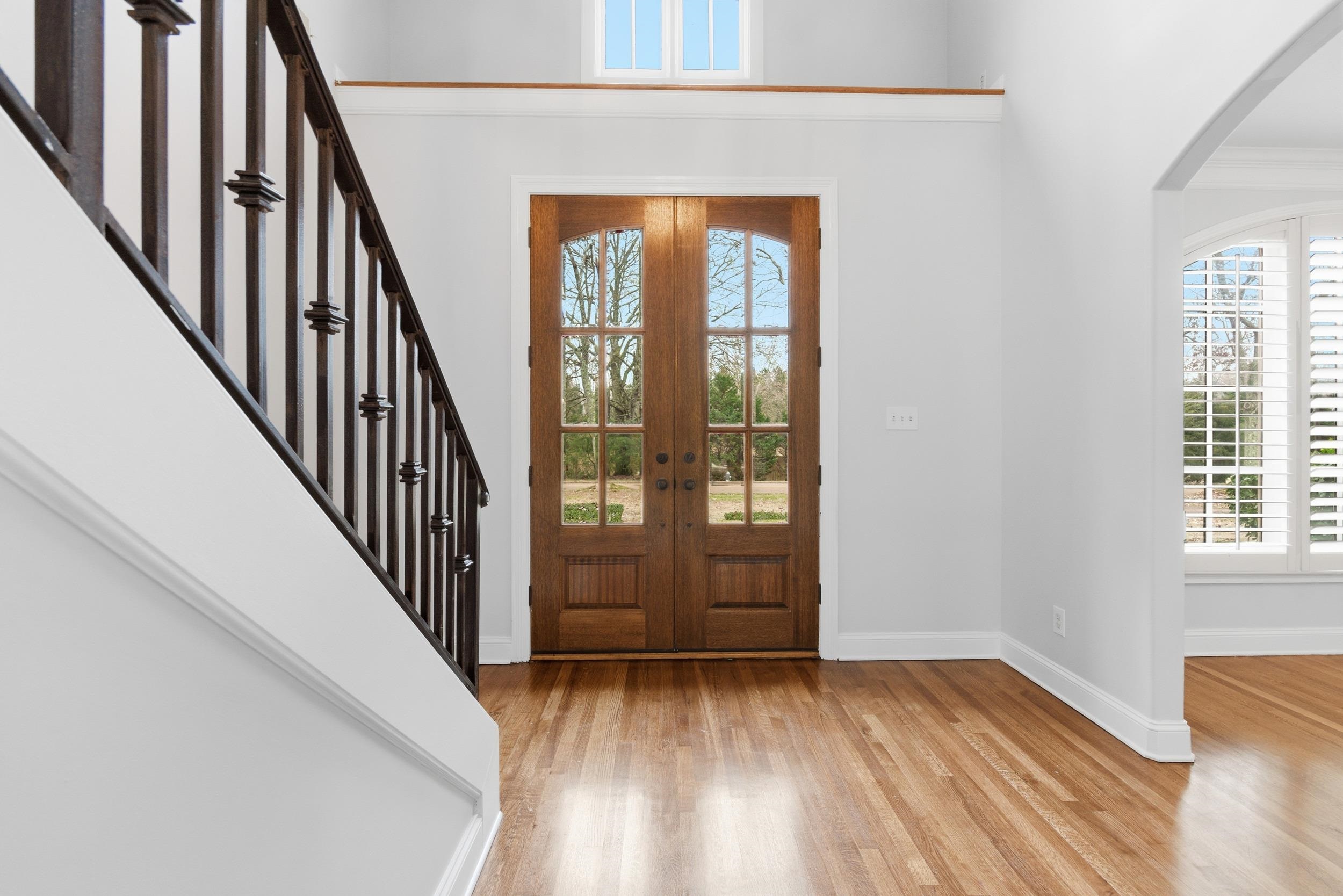 11080 Shelby Post Road Collierville, TN 38017 - Photo 5 of 39 Entrance foyer featuring arched walkways, french doors, light wood finished floors, plenty of natural light, and ornamental molding