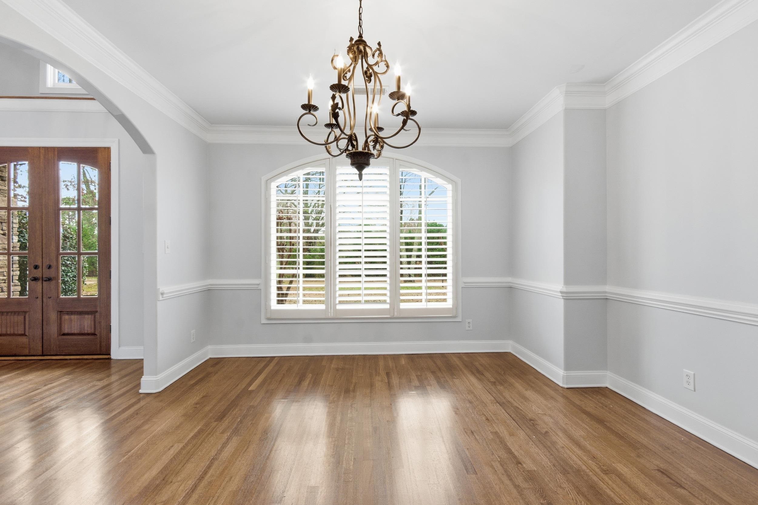 11080 Shelby Post Road Collierville, TN 38017 - Photo 6 of 39 Foyer entrance with french doors, wood finished floors, a chandelier, crown molding, and arched walkways