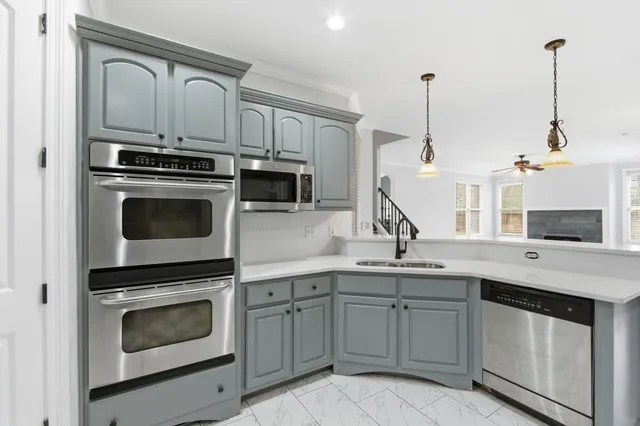 a kitchen with a sink stove and microwave
