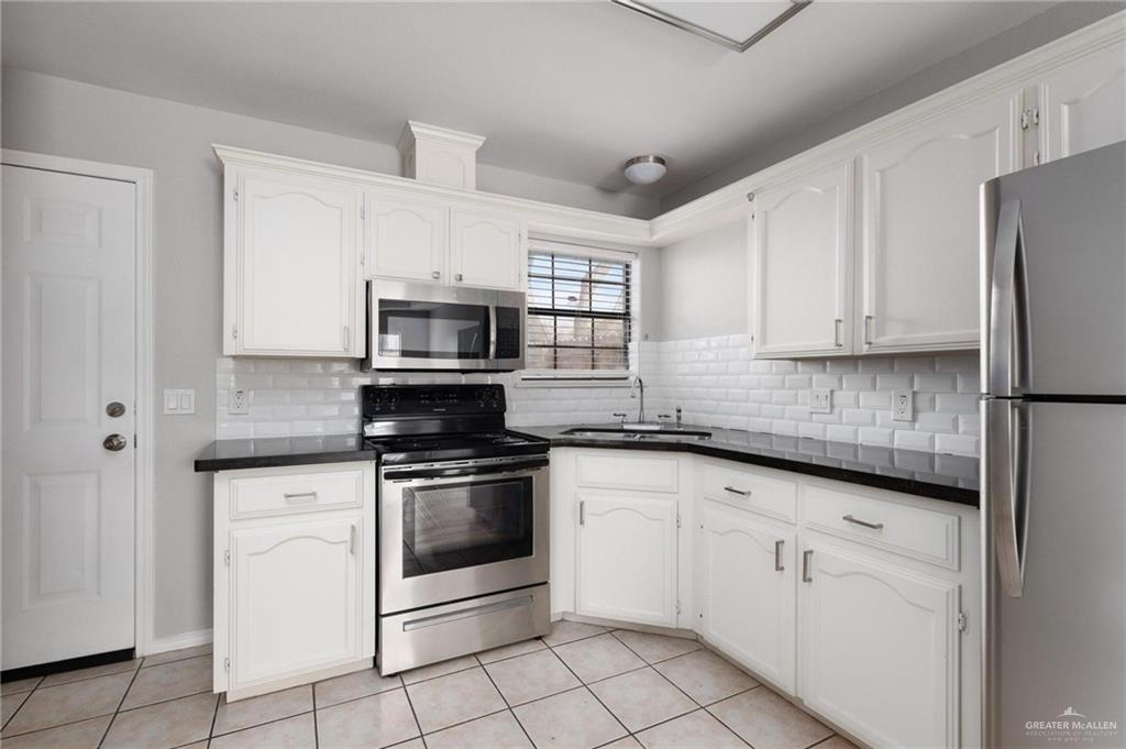 3505 Amando Street, Unit 3 Edinburg, TX 78539 - Photo 5 of 17 a kitchen with white cabinets stainless steel appliances and sink