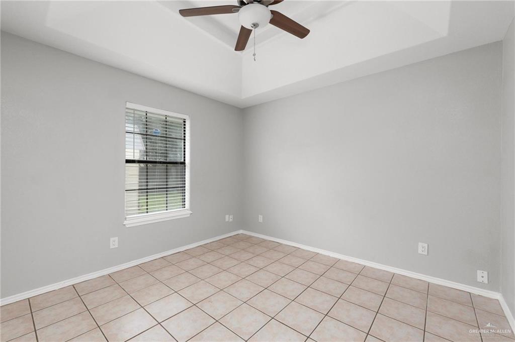 3505 Amando Street, Unit 3 Edinburg, TX 78539 - Photo 7 of 17 an empty room with windows and ceiling fan