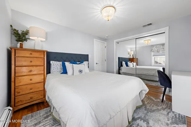 a bedroom with a bed and a dresser