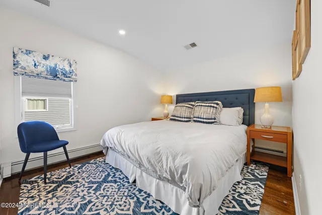 a bedroom with a bed and a chair