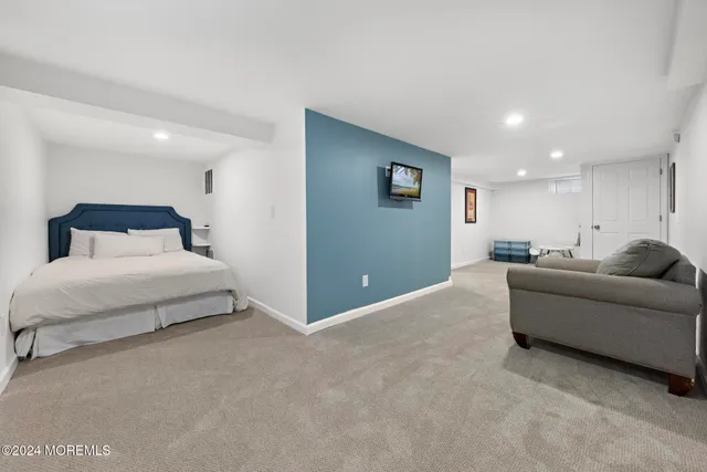 a bedroom with a bed and a couch