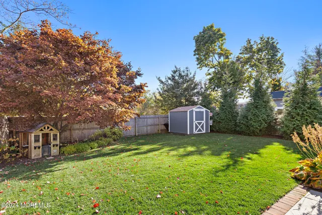 a view of a garden with a house in the background