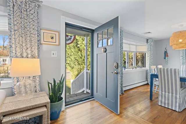 a view of livingroom with hardwood floor and floor to ceiling window