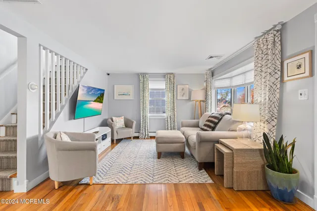 a living room with furniture lamp and a potted plant