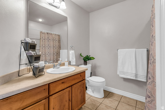1136 West Spencer Road, Unit Y203 Pleasant Grove, UT 84062 - Photo 20 of 26 Full bathroom featuring curtained shower, vanity, and light tile patterned floors