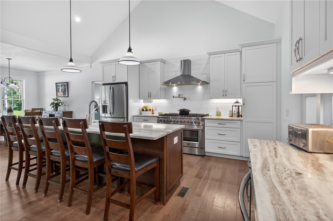 921 Falling Waters Lane Seneca, SC 29672 - Photo 13 of 46 Culinary aspirations thrive in this kitchen, boasting vaulted ceilings and a sprawling island for gathering.