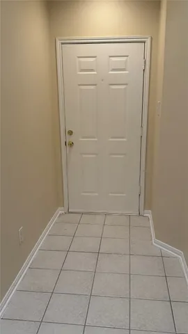 a view of a livingroom with wooden floor and a kitchen space