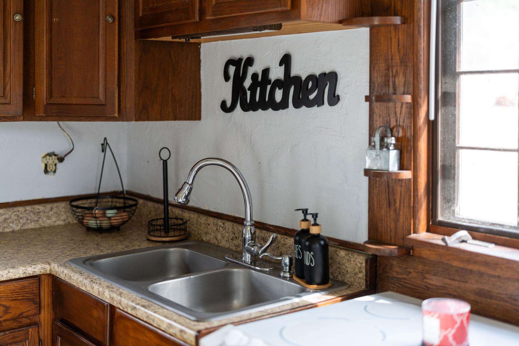 503 Augusta Avenue Grottoes, VA 24441 - Photo 21 of 61 a kitchen with a sink and a stove with wooden floor