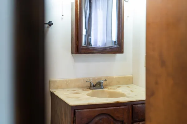 a brick house with a tree in front of it