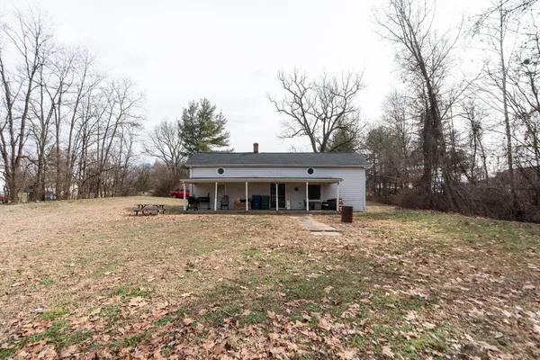 a view of house with outdoor space and sitting area