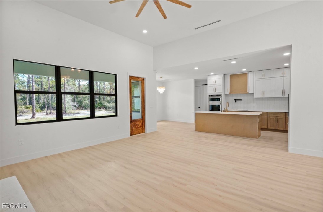 2310 Columbus Avenue Alva, FL 33920 - Photo 16 of 43 a large kitchen with kitchen island a large window and a sink