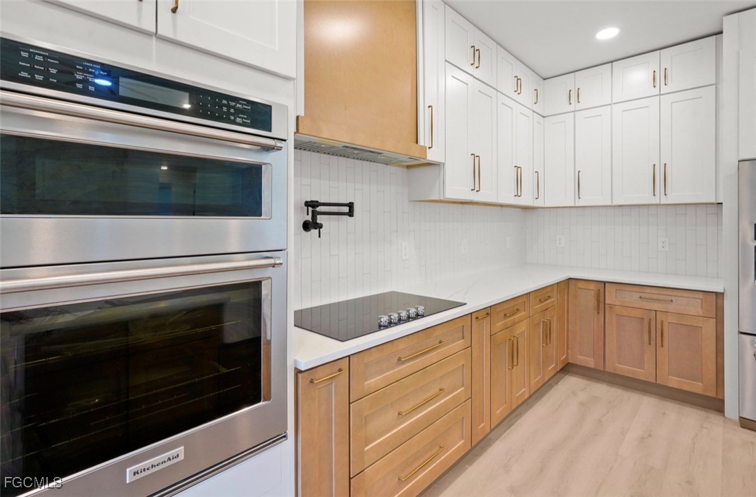 2310 Columbus Avenue Alva, FL 33920 - Photo 18 of 43 a kitchen with granite countertop white cabinets and black appliances