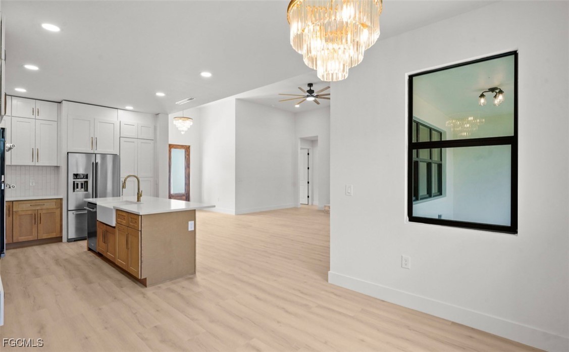 2310 Columbus Avenue Alva, FL 33920 - Photo 23 of 43 a living room with stainless steel appliances kitchen island granite countertop furniture and a chandelier