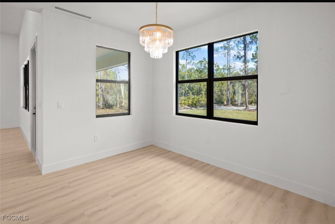 2310 Columbus Avenue Alva, FL 33920 - Photo 24 of 43 an empty room with wooden floor and windows