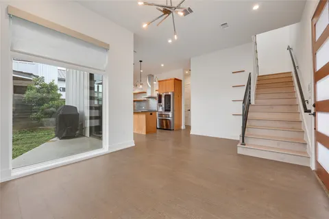 a view of an empty room with a fireplace and a window