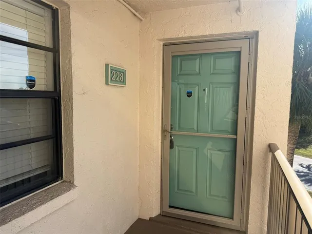 a view of a hallway with wooden door