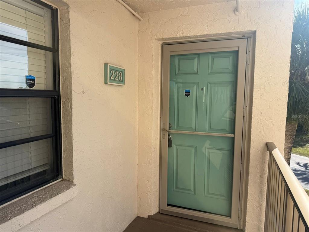 a view of a hallway with wooden door