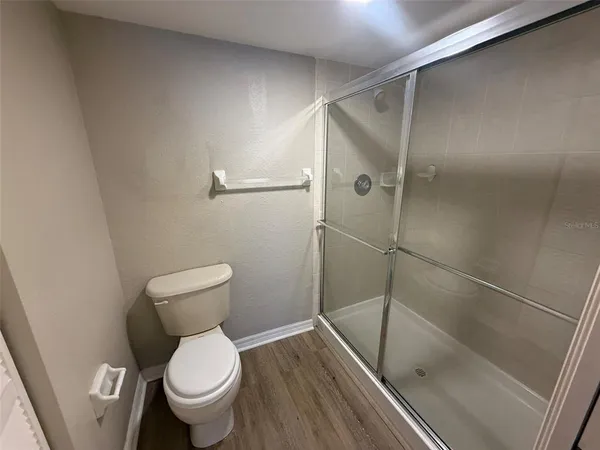 a bathroom with a toilet and a shower