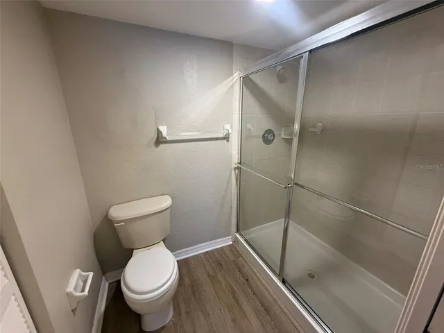 a bathroom with a toilet and a shower