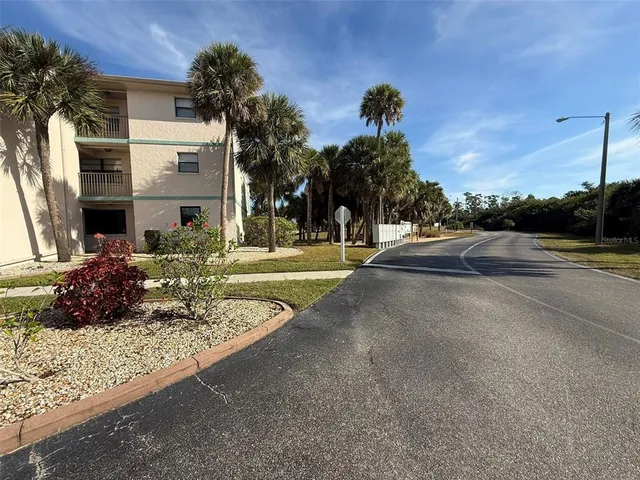 a view of a house with a yard and a fountain