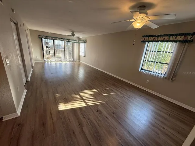 wooden floor in an empty room with a window