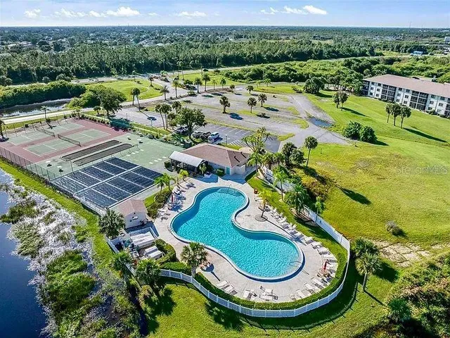 a view of a swimming pool with a patio and a garden