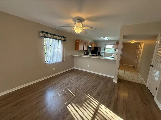 a view of a kitchen with wooden floor and a kitchen space