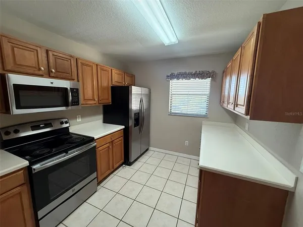 a kitchen with stainless steel appliances a stove a microwave and a refrigerator