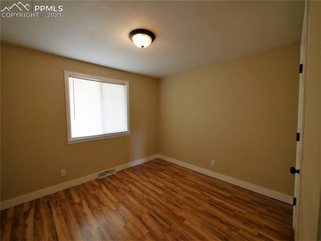 402 Yellowstone Road Colorado Springs, CO 80910 - Photo 12 of 28 Upper Bedroom 1 facing window