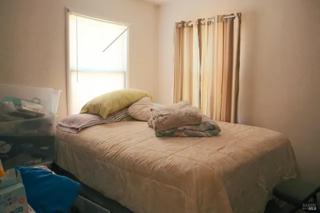 a bedroom with a bed a couch and dresser