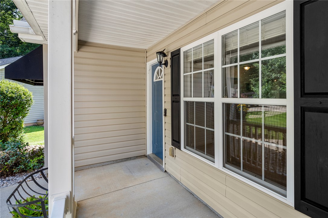 167 Mediterranean Avenue Anderson, SC 29621 - Photo 5 of 33 A welcoming front porch features vinyl siding and a charming blue entry door.