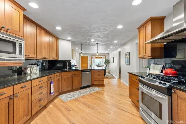 a large kitchen with a table and chairs