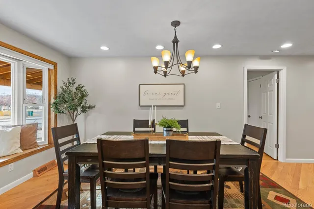 a view of a dining room with furniture and chandelier