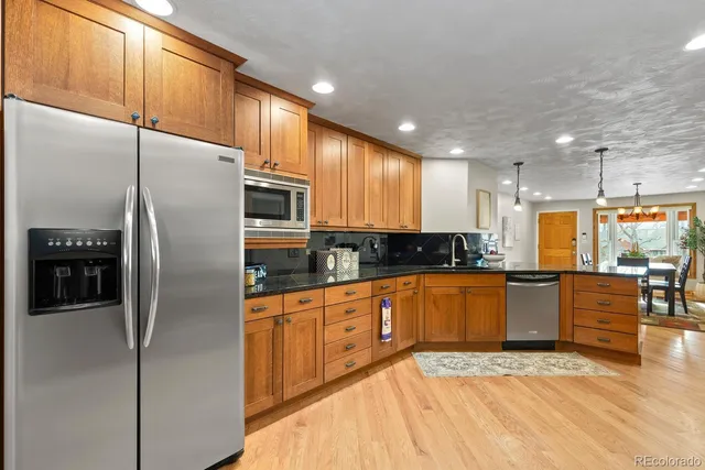 a bathroom with a granite countertop sink a mirror and a shower