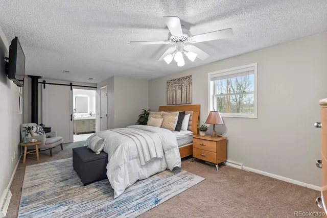 a bathroom with a granite countertop sink mirror vanity and toilet