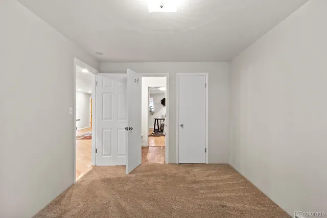 a bathroom with a toilet sink vanity and mirror