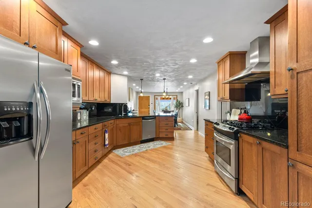 a kitchen with a stove and a refrigerator