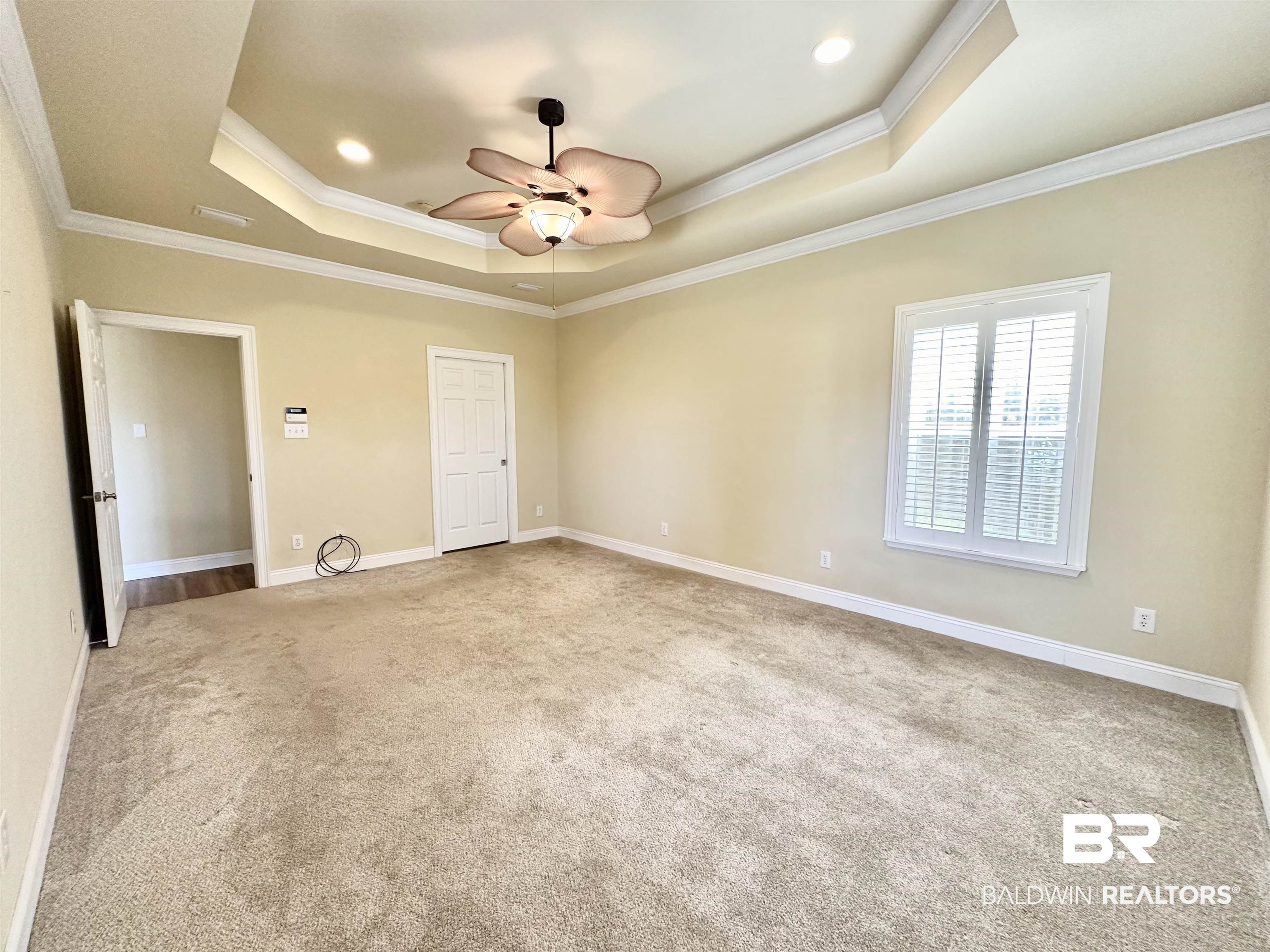 249 Hemingway Loop Foley, AL 36535 - Photo 11 of 33 Unfurnished bedroom featuring crown molding, a tray ceiling, light colored carpet, and ceiling fan