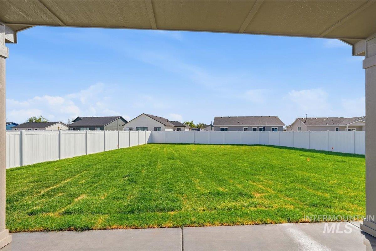 2175 Austin Way Fruitland, ID 83619 - Photo 27 of 30 Fenced backyard with a residential view and a patio area