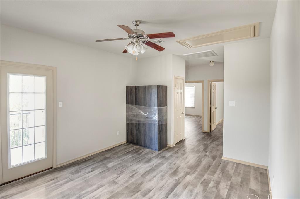 10033 Butte Meadows Drive Fort Worth, TX 76177 - Photo 17 of 31 an empty room with wooden floor and windows