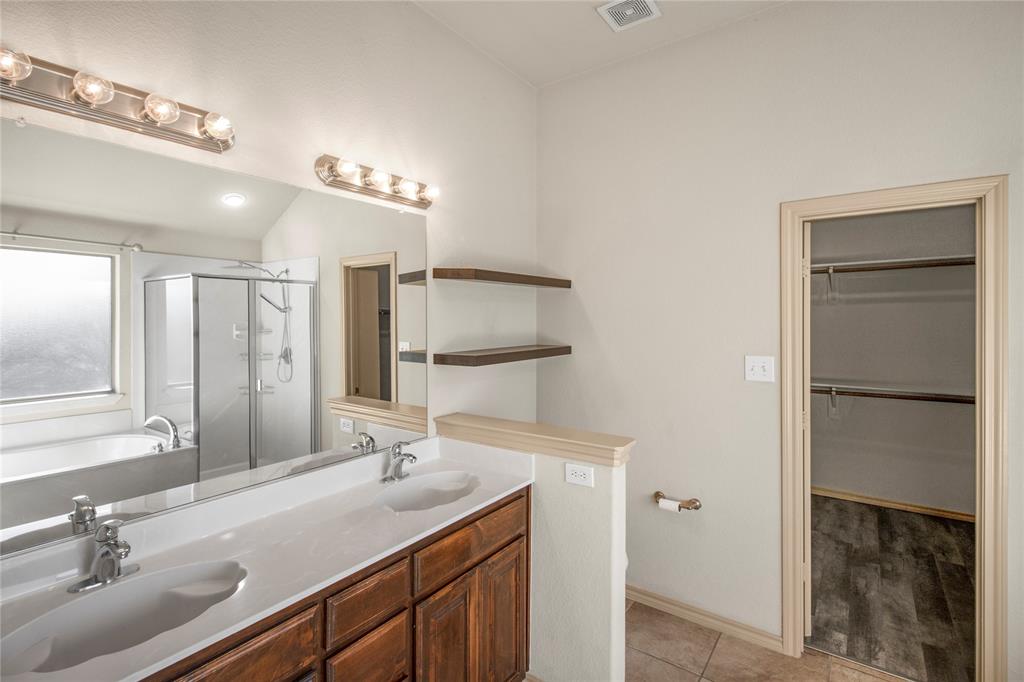 10033 Butte Meadows Drive Fort Worth, TX 76177 - Photo 26 of 31 a bathroom with a sink double vanity and a mirror
