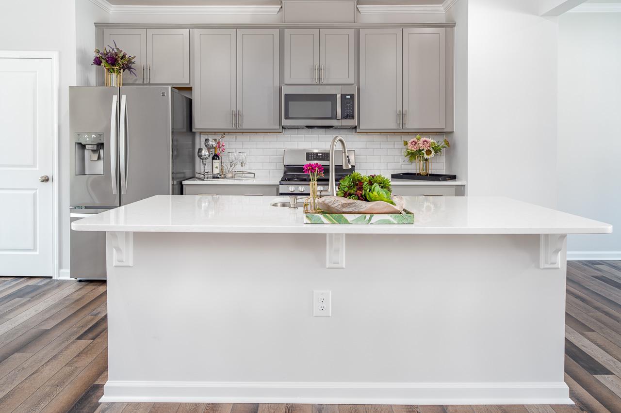 1434 Rosepine Drive Cary, NC 27519 - Photo 11 of 32 a kitchen with stainless steel appliances a refrigerator a sink a stove a microwave and cabinets