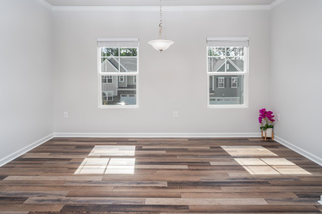 1434 Rosepine Drive Cary, NC 27519 - Photo 15 of 32 a view of an empty room with wooden floor and a window