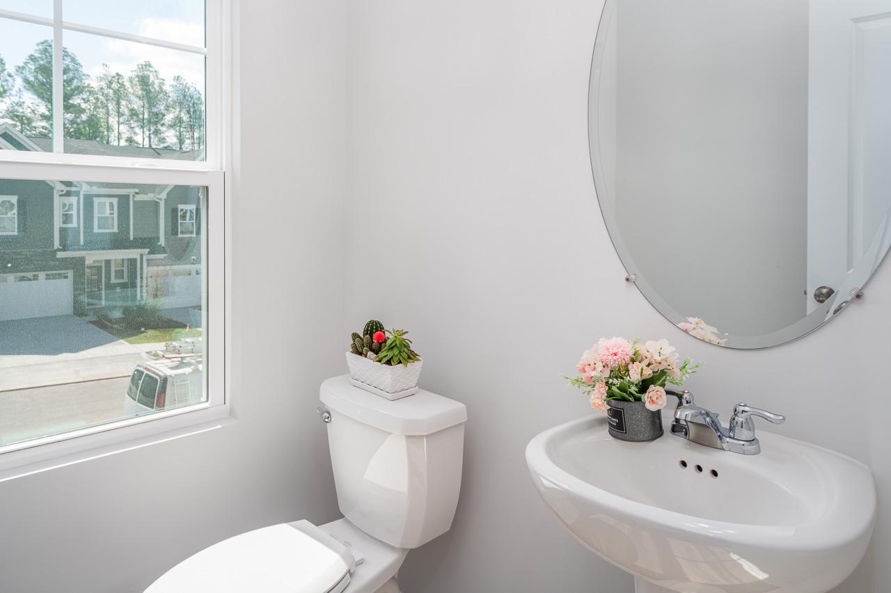 1434 Rosepine Drive Cary, NC 27519 - Photo 18 of 32 a bathroom with a toilet sink and a mirror