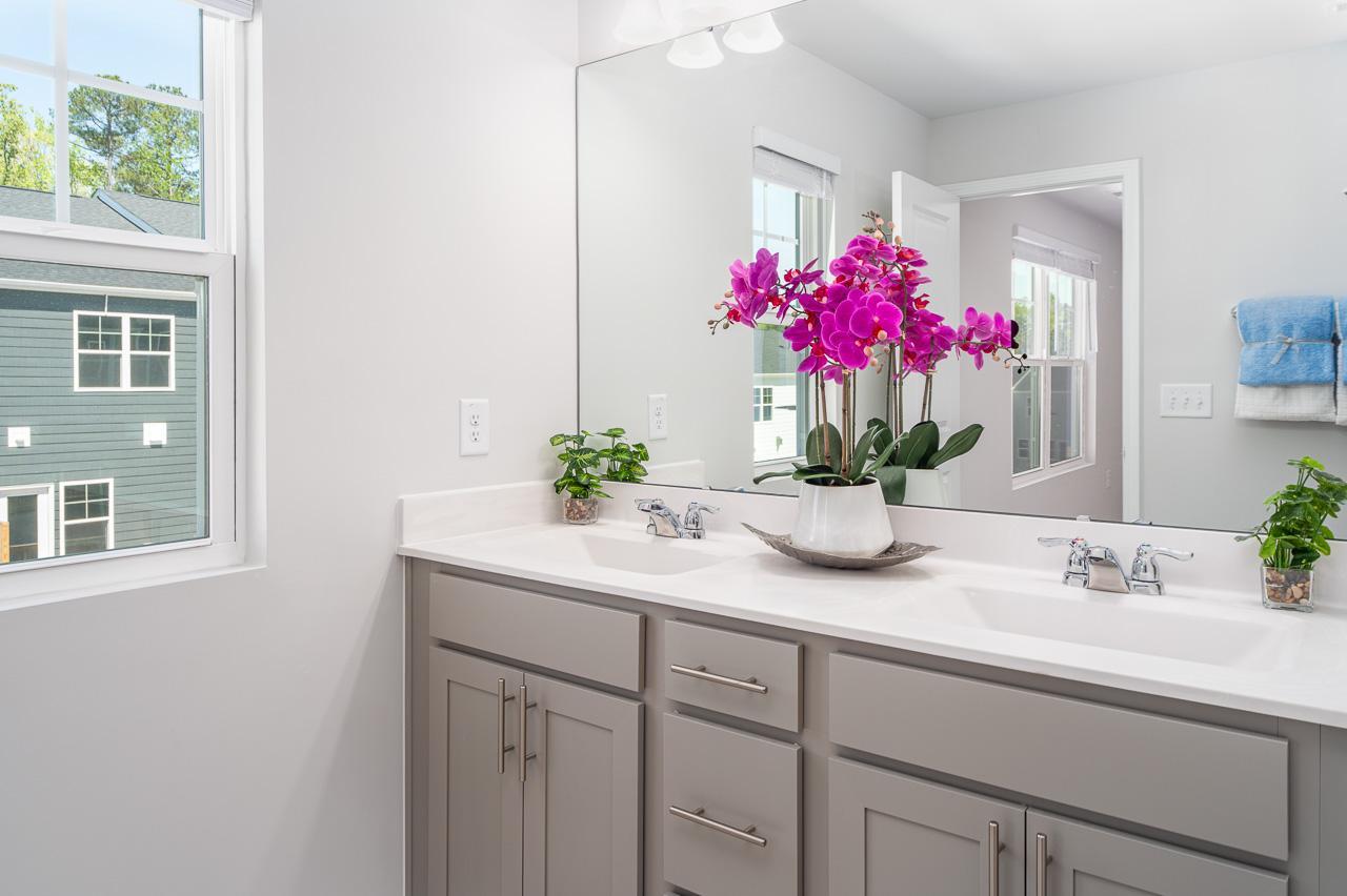1434 Rosepine Drive Cary, NC 27519 - Photo 21 of 32 a bathroom with a sink a vanity and a mirror
