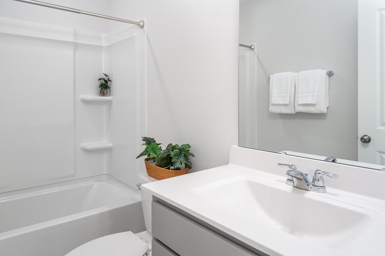 1434 Rosepine Drive Cary, NC 27519 - Photo 5 of 32 a bathroom with a sink a toilet and tub