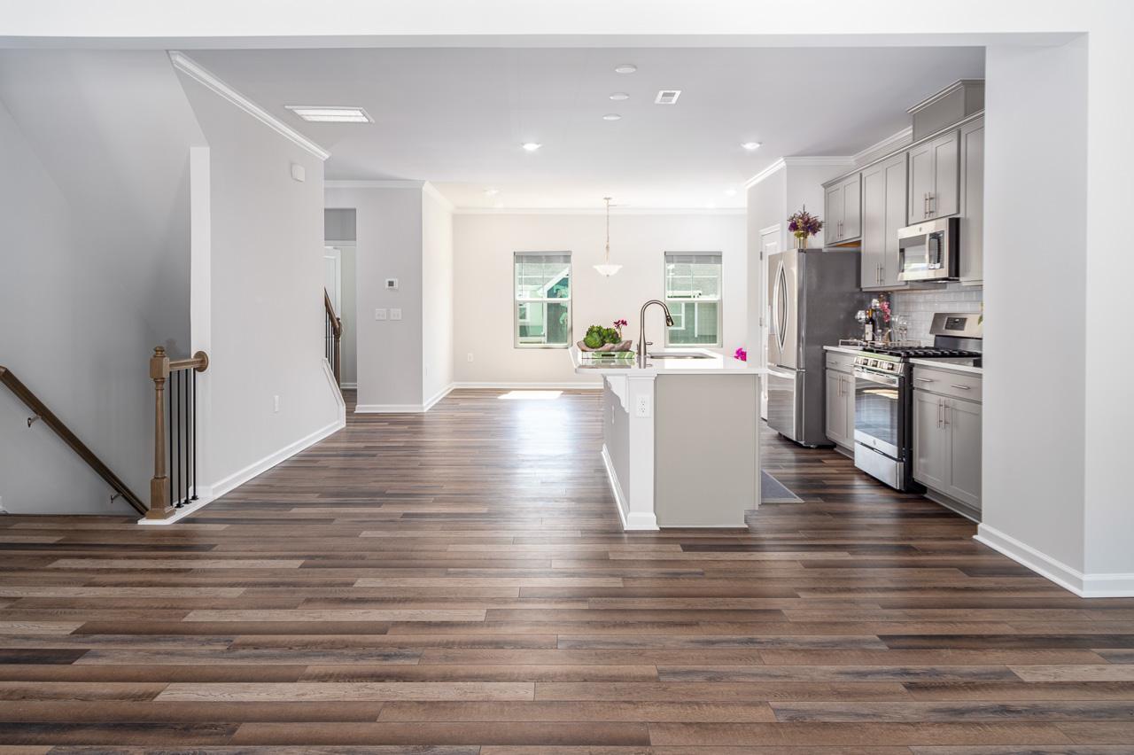 1434 Rosepine Drive Cary, NC 27519 - Photo 7 of 32 a view of a kitchen with cabinets and wooden floor